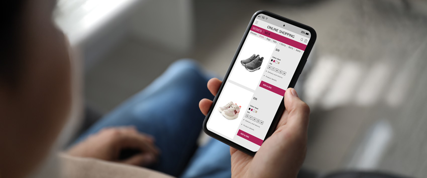 Three trail runners on an open mountain trail heading towards a range of snowy peaks