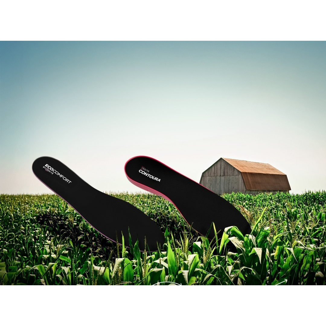 Two Insite plant-based insoles against a farm background