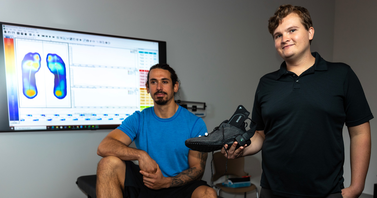 Biomechanics Pressure Testing scientist and subject in lab with foot heat map