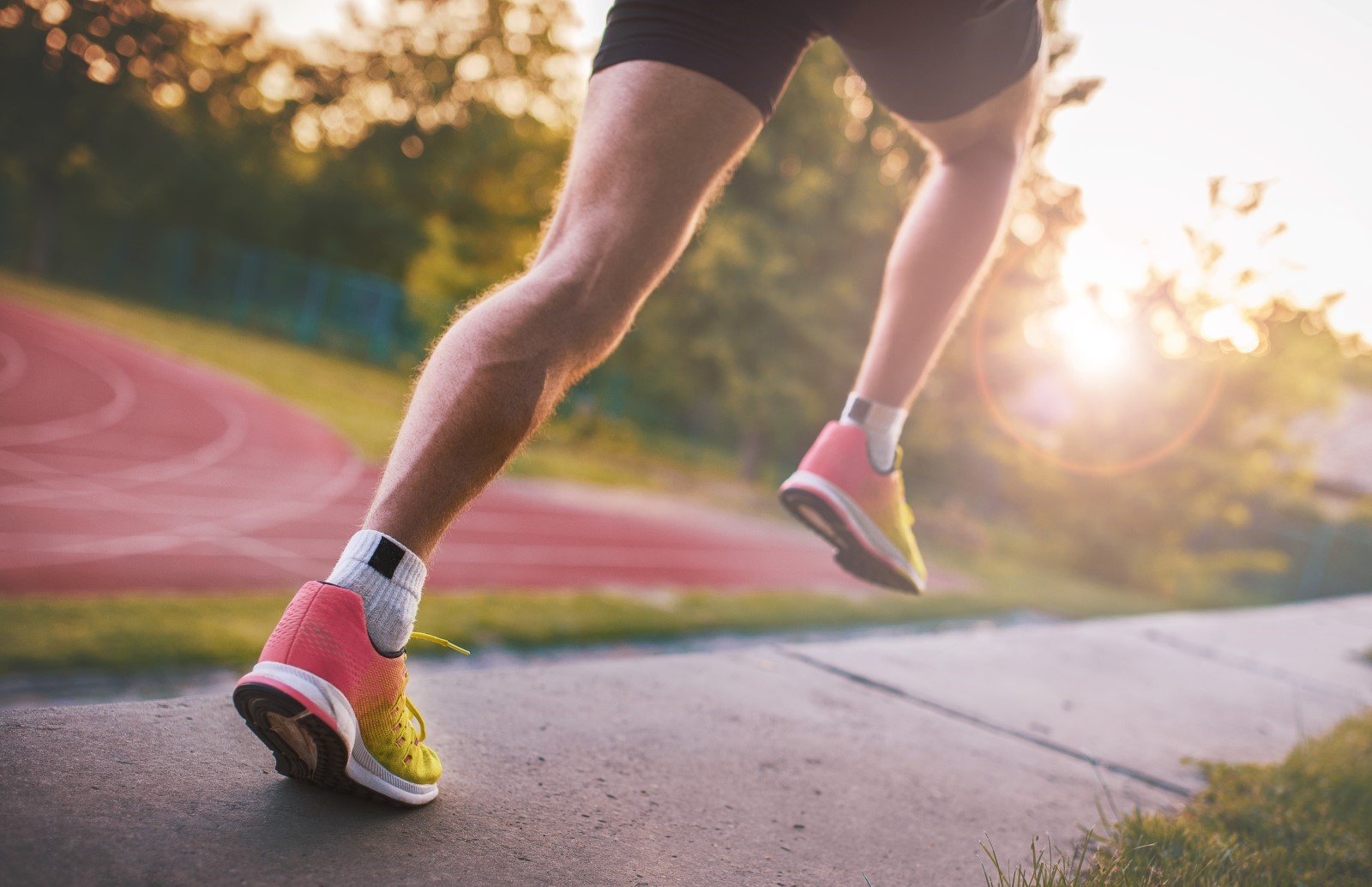 A closeup of a person's legs mid-sprint on a track.