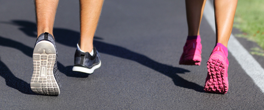 joggers walking on a paved path