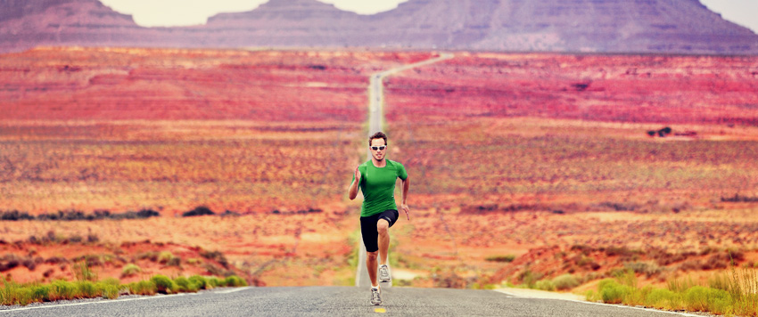 Man running long distance on a dessert road
