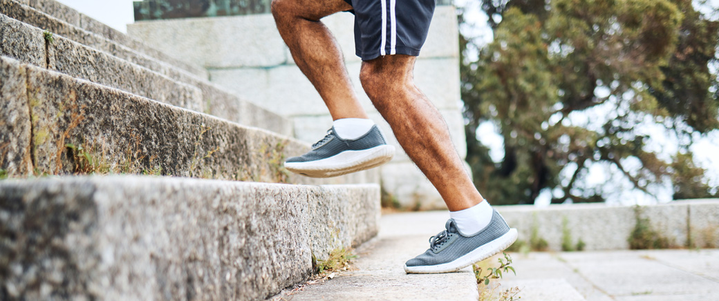person running up stairs with athletic shoes